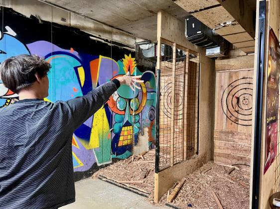 Yuta throwing axe at Axe Throwing Bar