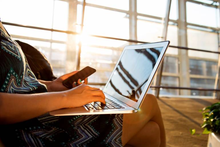 woman laptop mobile smart phone airport travel on the go